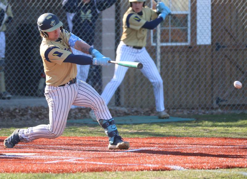 Marquette's Jaxsen Higgins smacks a hit against Newark on Monday, March 23, 2026 at Newark High School.