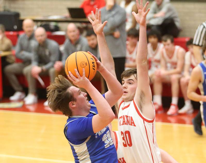 Princeton's Jordan Reinhardt eyes the hoop as Ottawa's Seth Cooper defends on Monday, Feb. 3, 2025 in Kingman Gymnasium at Ottawa High School.