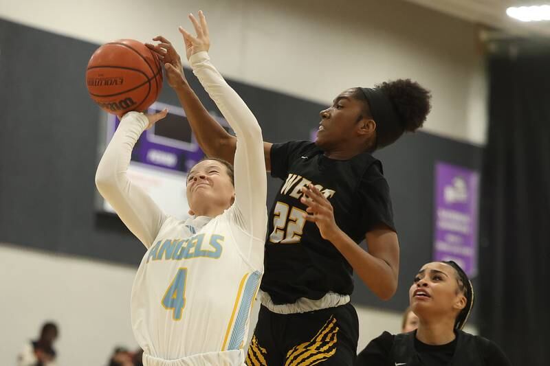 Joliet West’s Makayla Chism blocks a shot by Joliet Catholic’s Camryn Kinsella in the 2023 WJOL Girls Basketball Tournament on Friday, Nov. 17, 2023, in Joliet