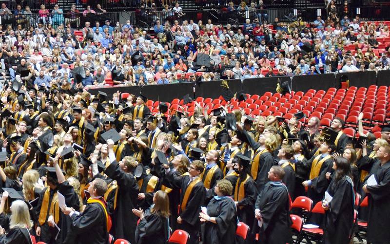 Sycamore High School seniors toss their caps into the air to celebrate their graduation. The commencement ceremony was held Sunday, May 22, 2022 at Northern Illinois University's Convocation Center in DeKalb.