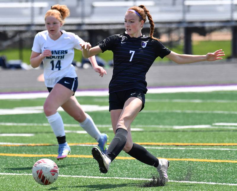 Downers Grove North’s Audrey Anderson (7) kicks the ball ahead of Downers Grove South’s Hannah Hake (14) during a game on May 10, 2025 at Downers Grove North High School in Downers Grove .