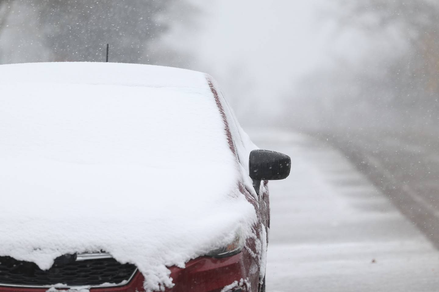 Snow covers a car in a residential area of Joliet on Thursday, Nov. 21, 2024.