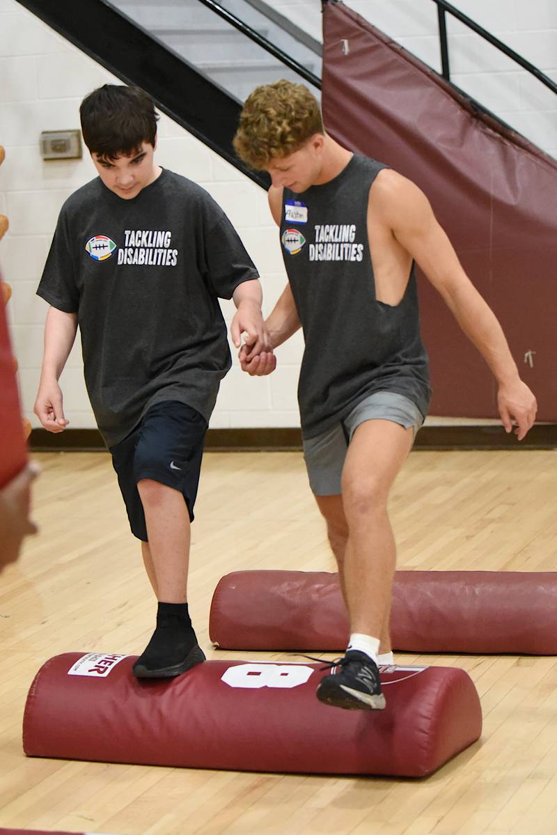 Oliver Watson, left, and Austin Morris work through a drill at Watseka's Tackling Disabilities football camp Saturday, July 26, 2025.