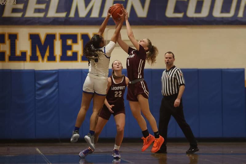 Joliet Central’s Joyce Tua-Link and Lockport’s Patricija Tamsauskas battle for the rebound.