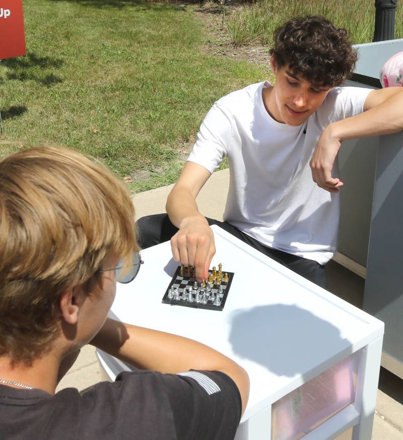 Tony Zurella, (right) from Lockport, plays chess while he waits for his girlfriend, an incoming student at Northern Illinois University, to get her key so he can help her move in Wednesday, Aug. 21, 2024, at Patterson Hall during the first of two move-in days for new students at NIU in Dekalb.