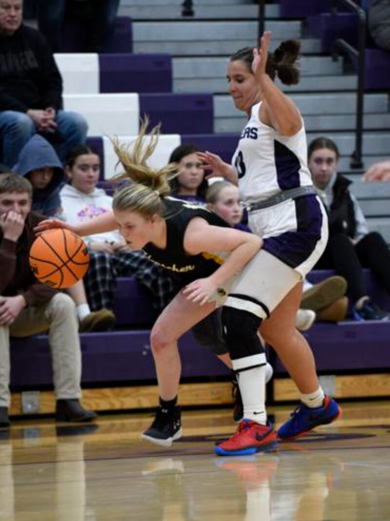 Herscher's Elsie Hoffman works around Manteno's Macy Iwanus as she tightly guards during Thursday's game in Manteno.