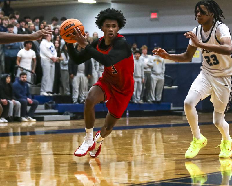 Bolingbrook's TJ Williams (3) drives to the basket during their basketball game between Bolingbrook at Oswego East Friday, Jan 30, 2026 in Oswego.