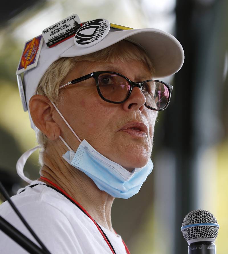 McHenry County Board member Paula Yensen, also the president of the McHenry County National Organization for Women, right, speaks to attendees during a rally for abortion rights on the historic Woodstock Square on Saturday, Oct. 2, 2021, in Woodstock.