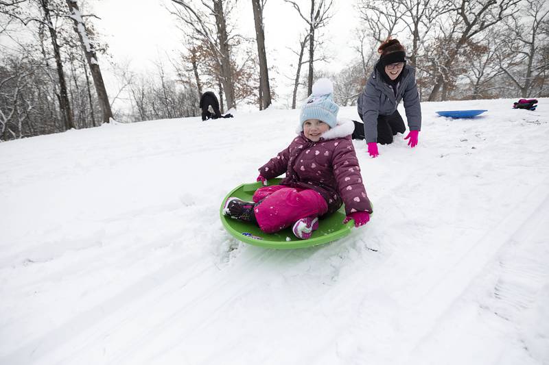 Kinsley Kibodeaux, 4, gets a shove from mom Elisha on Wednesday, Jan. 25, 2023 as the family has some fun on the sledding hill at Sinnissippi Park in Sterling. The kids got out of school early because of a teacher’s institute so they were able to take advantage of the fresh snowfall.