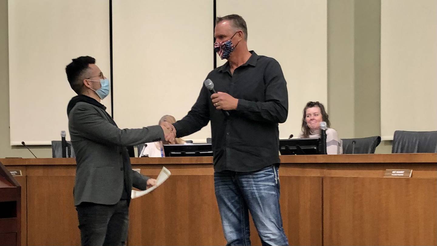 Oswego Village President Troy Parlier presenting Francisco "Frankie" Contreras with his certificate of recognition.