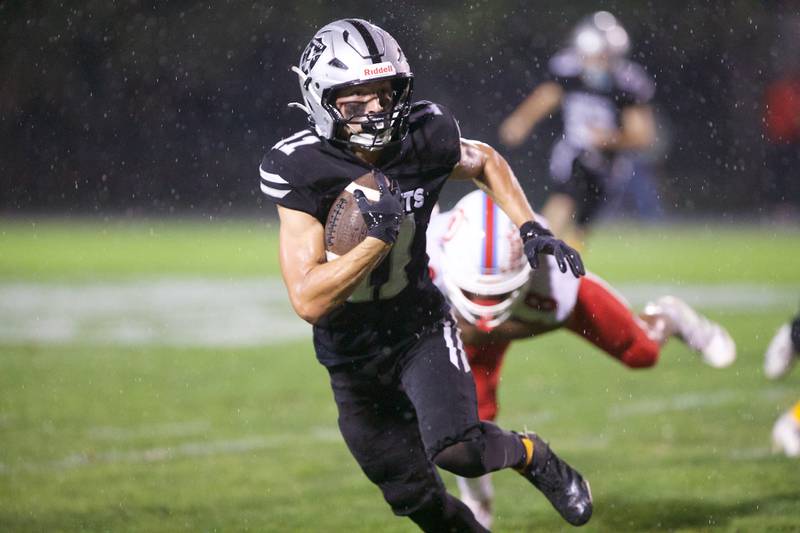 Kaneland's Brady Brown runs the ball for a gain against Ottawa on Friday, Sept. 19, 2025 in Maple Park.
