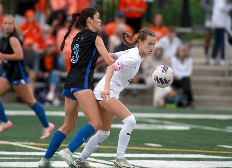 Wheaton Warrenville South's Ashlyn Adams and St. Charles North's Aubri Magana go after the ball during the Class 3A Glenbard West Sectional final on Friday, May 30, 2025 in Glen Ellyn.