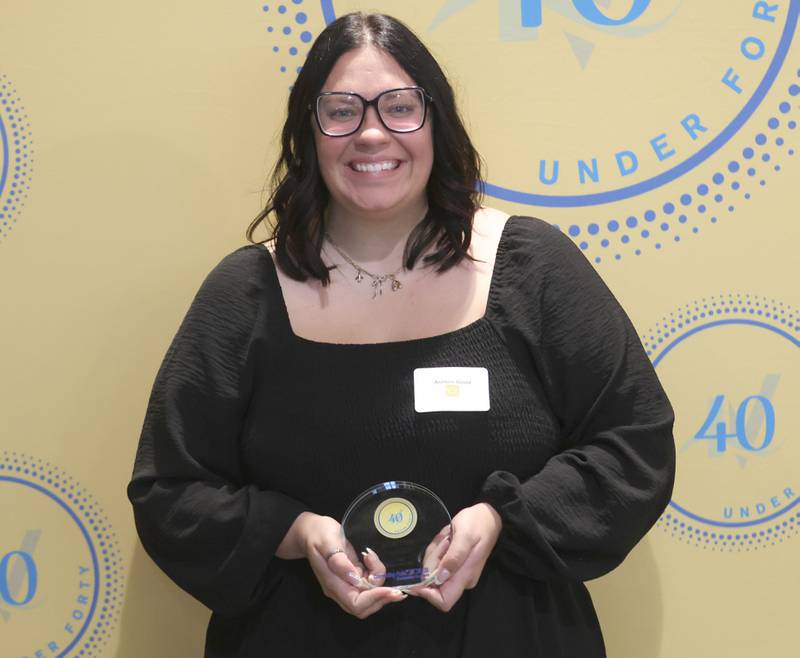 Ashton Good poses with her 40 Under Forty award during the Illinois Valley Chamber of Commerce Champions of Change Awards Night on Wednesday, May 6, 2026 at the Westclox Event Center in Peru.