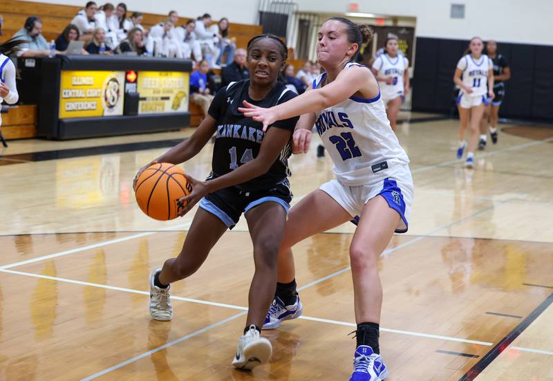 Kankakee's Jasyia Wesby drives to the basket under pressure from Rosary's Kayla Shimp during the Kays' 75-28 victory over Rosary at the Reed-Custer Classic on Monday, Nov. 17, 2025.