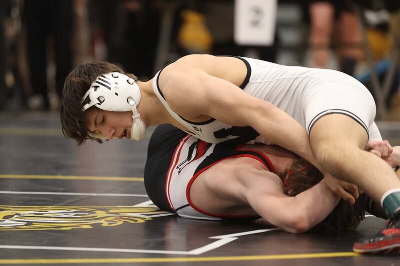 Plainfield North’s Aidan Durell works over Yorkville’s Nathan Craft in the 126-pound weight SPC Conference championship match at Joliet West on Saturday, Jan 25, 2025.