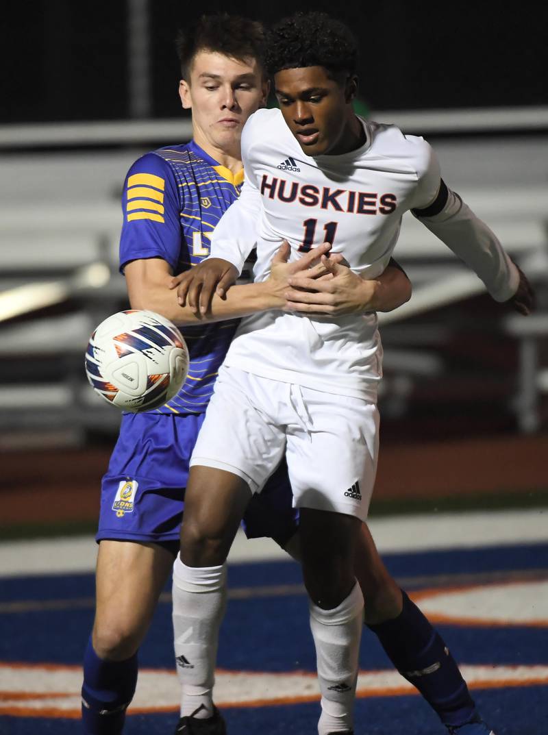 Lyons Township’s Collin Sullivan wraps up Naperville North’s Jaxon Stokes in the Class 3A state soccer semifinal game in Hoffman Estates on Friday, November 3, 2023.