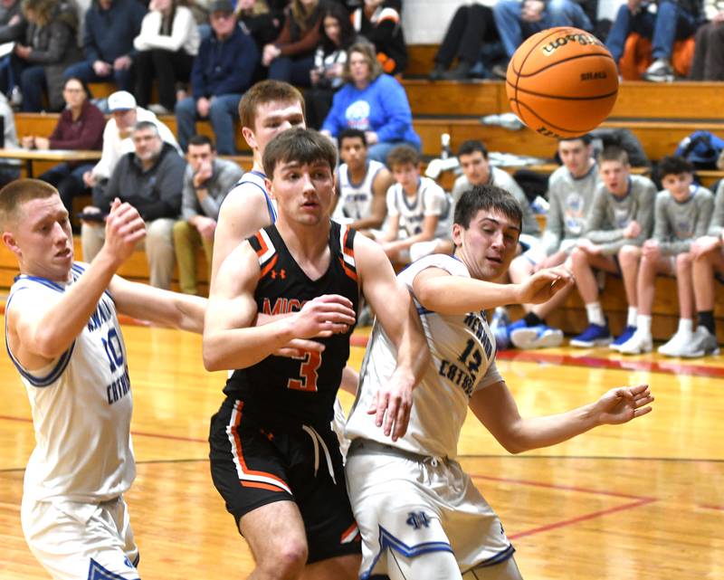 Sterling Newman's George Jungerman (10) and Evan Bushman (12) battle Milledgeville's Konner Johnson (3) for a loose ball at the 64th Annual Forreston Holiday Basketball Tournament at Forreston High School.