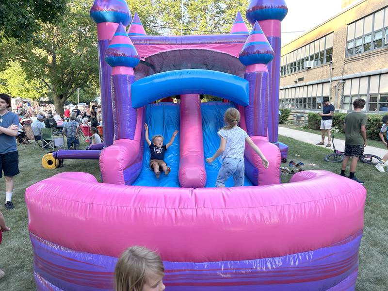 Kids play in one of the inflatables at the Let Freedom Ring block party on Friday, July 4, 2025 in Mt. Morris.