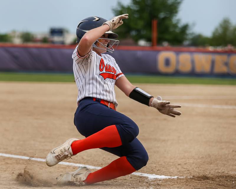Oswego's Marissa Moffett (5) slides into home during Class 4A Oswego Regional final softball game between Yorkville at Oswego. May 24th, 2024.