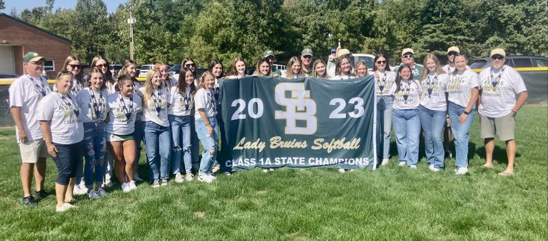 The St. Bede softball team display their 2023 Class 1A state championship banner at Abbot Philip Davey Field Saturday. St Bede rallied to unseat two-time defending state champion Glasford Illini Bluffs, 7-6, on June 3.