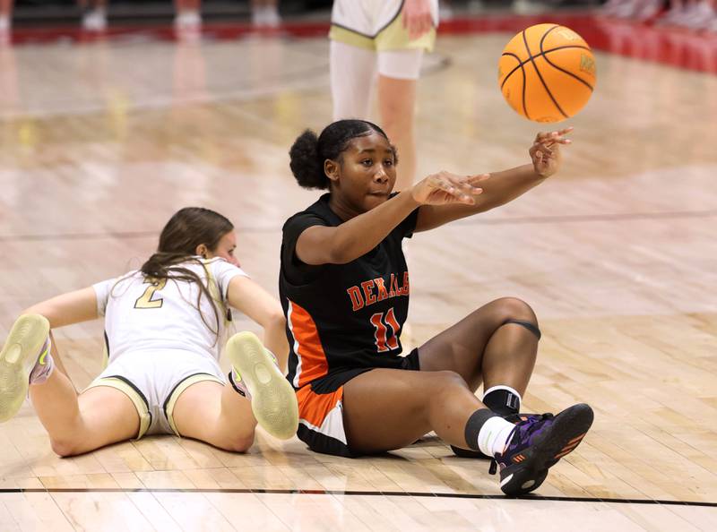DeKalb's Johnna Patrick passes the ball from the floor after winning a loose ball with Sycamore's Sydney Fabrizius during their game Friday, Jan. 31, 2025, in the FNBO Challenge in the Convocation Center at Northern Illinois University in DeKalb.