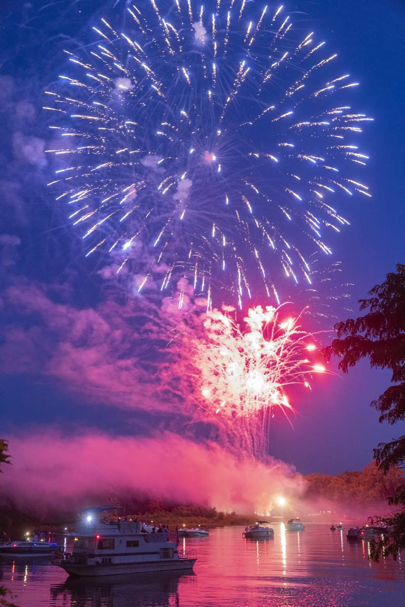 Boaters watch as fireworks burst overhead during the Monday, July 3, 2023, display on the Illinois River in Peru.