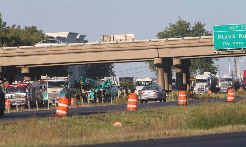 Emergency crews work the scene of a semi truck that struck the overpass of Illinois Route 251 and Interstate I-80 on Friday, Sept. 26, 2025 in Peru. The driver of the semi had to be extricated. Illinois State Police, Peru Fire and EMS,  Senica Towing and Illinois Department of Transportation were all on the scene.