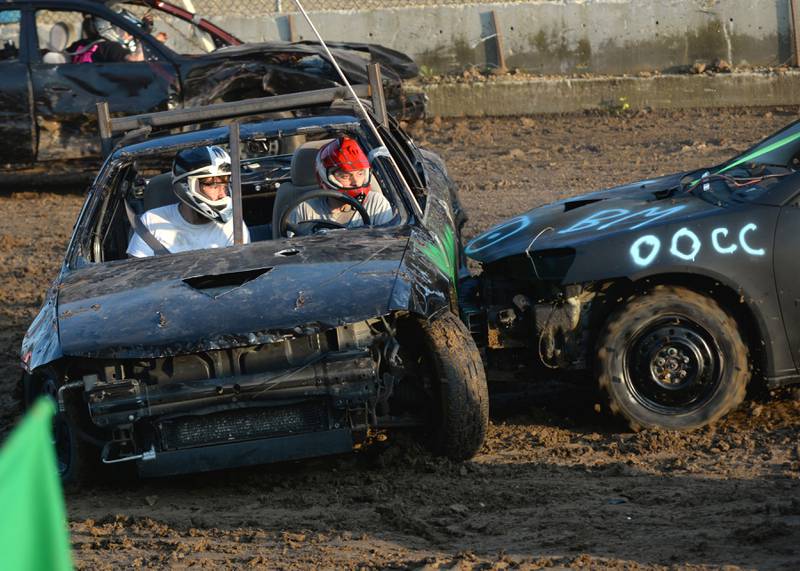 Kenan Collision of Dixon and his passenger Andrew McKenna take a hit in the Bonestock heat of the demolition derby at the Ogle County Fair on Saturday, Aug. 3, 2024.