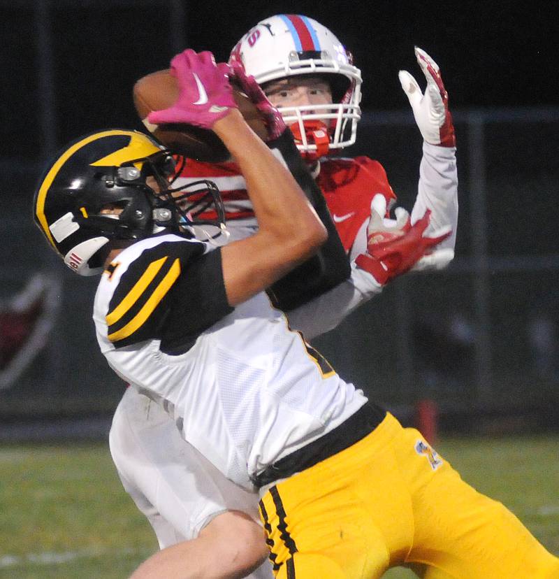 Harvard's Cristian Pagles (1) catches a pass despite the defense of Ottawa's Hayden Swett at King Field on Friday, Sept. 8, 2023.