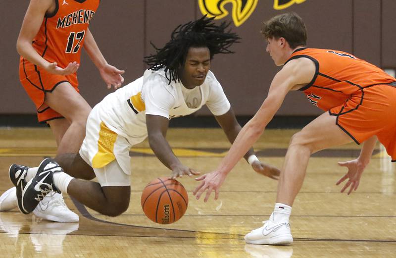 Jacobs' Emaan Thomas tries to control the ball as he falls to the floor in front of McHenry's Dylan Hurckes after being fouled during a Fox Valley Conference boys basketball game on Wednesday, Nov. 29, 2023, at Jacobs High School in Algonquin.
