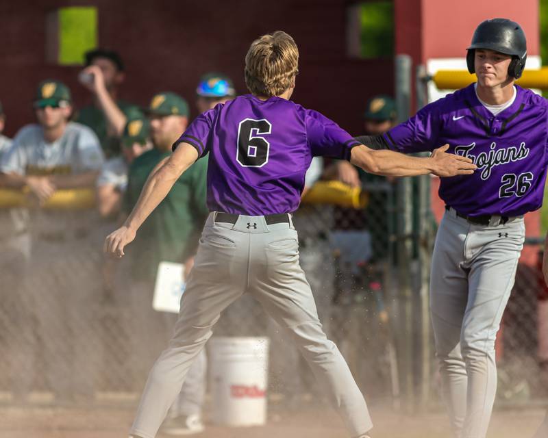 Downers Grove North's Luke Fordonski (6) celebrates at home with Jack Romsey (26) after scoring a run to tie the game during Class 4A Sectional Final Championship game between Downers Grove North at Waubonsie Valley.  May 31, 2024