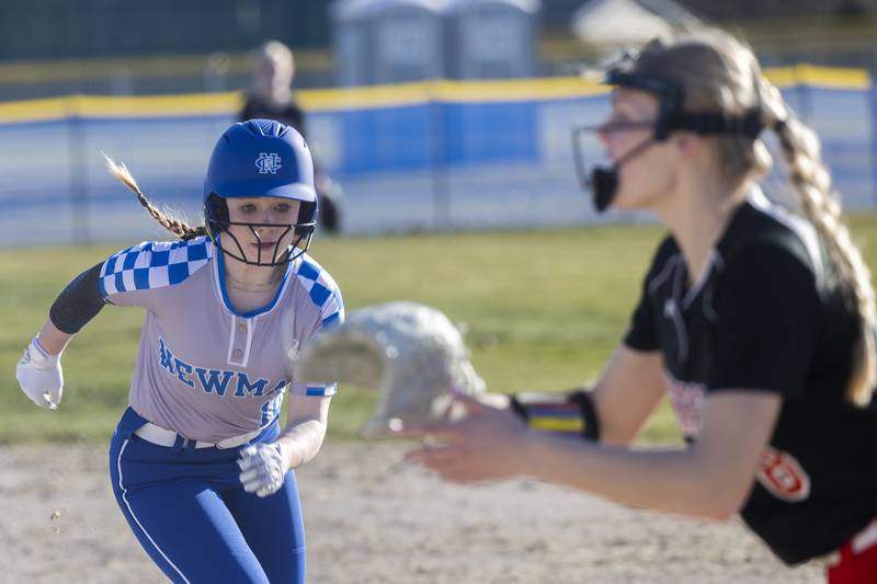 Newman’s Kaylee Benyo dashes back to first Burt was doubled off on a caught line drive against Forreston Monday, March 11, 2024.