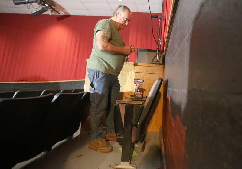DuWayne Polte removes seating inside Stage 212 on Tuesday, Aug. 12, 2025 in La Salle. Polte, who is employed with GAF, donated his time to help with the renovation.