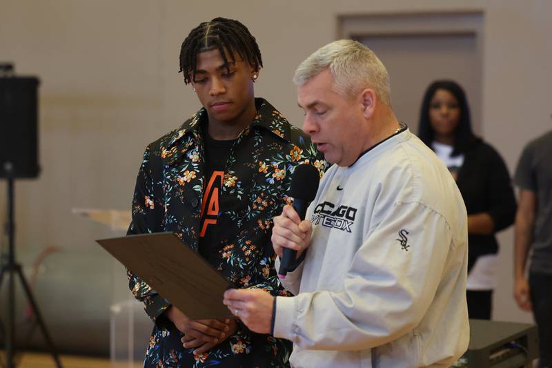 Joliet Mayor Bob O’Dekirk (right) reads a proclamation presented to Jeremy Fears Jr. Friends and family host a reception for Joliet West’s basketball player Jeremy Fears Jr. before he heads to Houston to play in the All-McDonalds game.