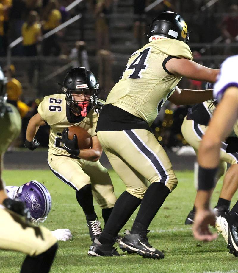 Sycamore's Crewe Bartelt follows the blocking of teammate Clyde Nott for a nice gain during their game against Rochelle Friday, Sept. 19, 2025, at Sycamore High School.