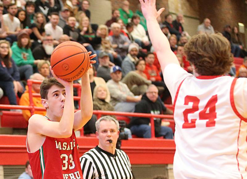 L-P's Nicholas Olivero shoots a jump shot over Ottawa's Trace Roether in Kingman Gymnasium on Friday, Feb. 10, 2023 at Ottawa High School.