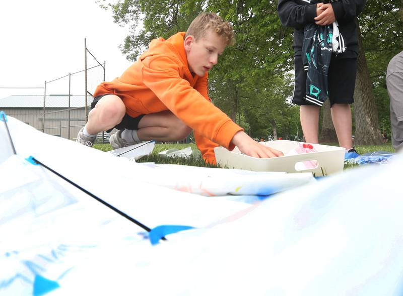 Nathan Johnson of Princeton collects materials to build his kite during the Second Story Teen Center kite flying contest on Wednesday, May 20, 2026 at City County Park in Princeton. 
The event featured over 2 dozen kites, hot dogs, games and more.