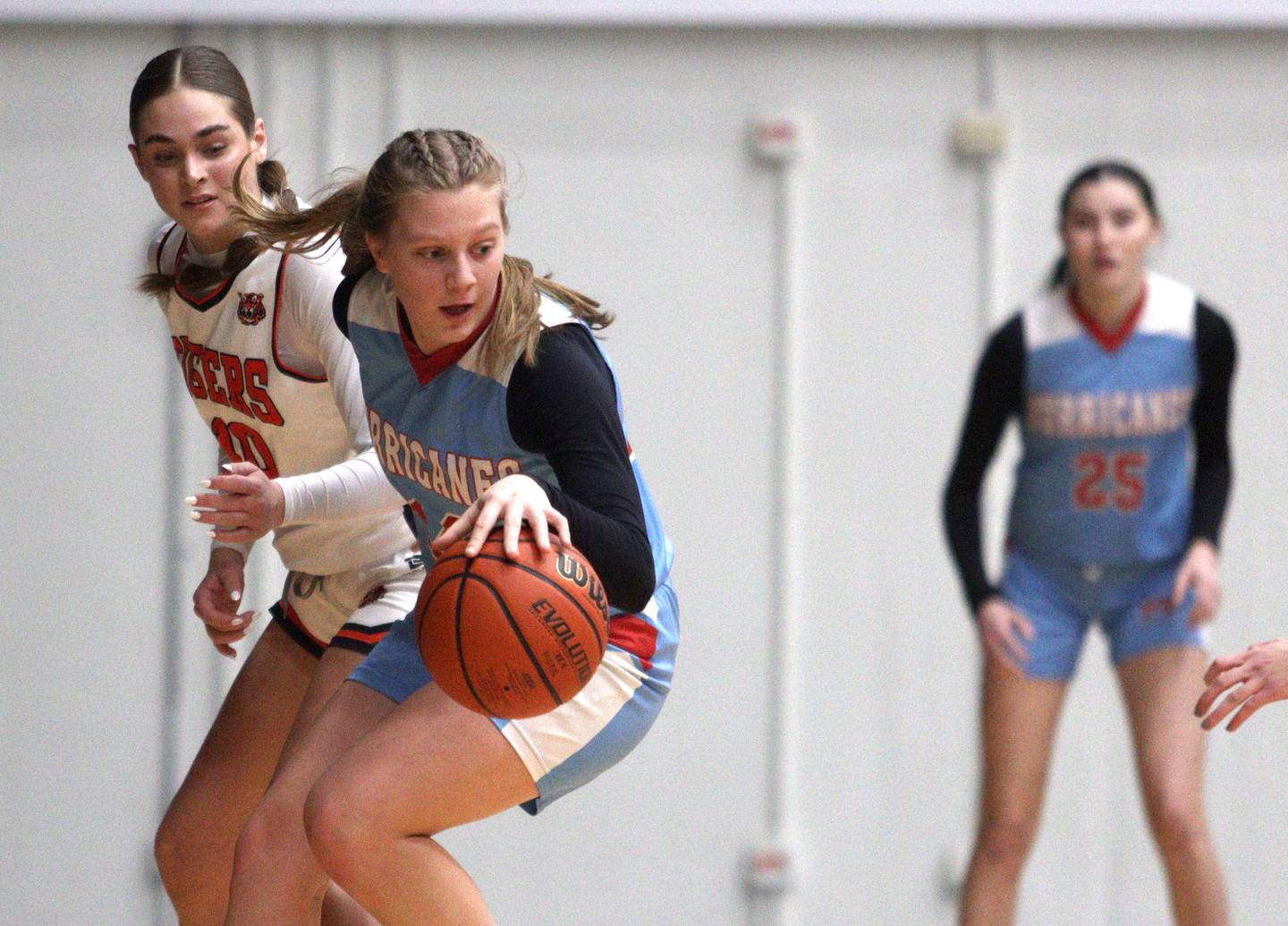 Crystal Lake Central’s  Avery Bechler, left, follows the ball as Marian Central’s Abbey Miner, front, looks for an option in Northern Illinois Holiday Classic championship girls basketball game action at  McHenry High School Thursday.