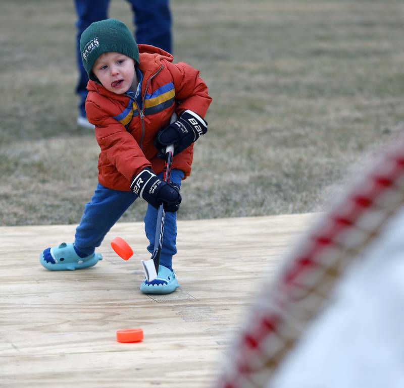 Three-year-old Carter Cankar of Wheaton works on his slap shot during Ice-A-Palooza Saturday, Feb. 8, 2025 at the Central Athletic Complex in Wheaton.