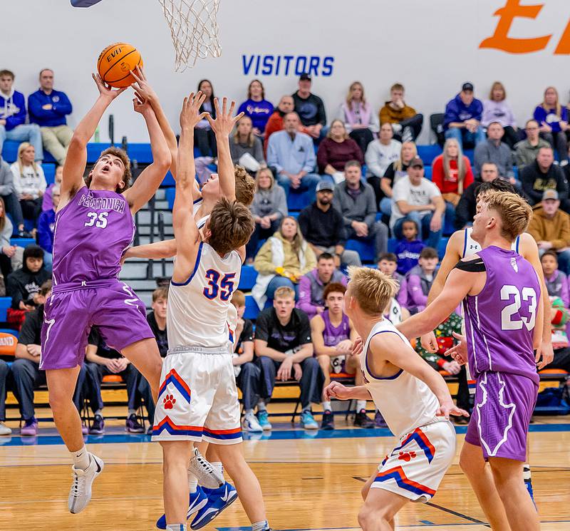 Pecatonica's Colton Maurer puts up a shot against two Eastland defenders during the final night of play at the Eastland Holiday Tournament on Thursday, Dec. 19, 2024.