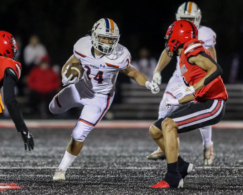 Oswego's Ayden Villa (24) runs with the ball during a football game between Oswego at Bolingbrook on Friday, Oct 4th, 2024  in Bolingbrook.