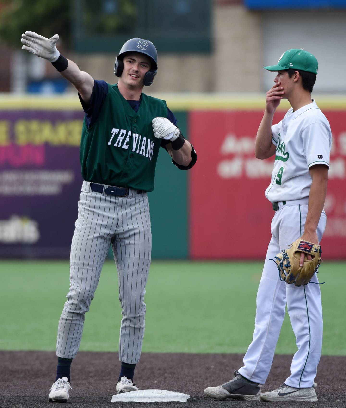 Joe Lewnard/jlewnard@dailyherald.com
New Trier’s Dylan Mayer, left, celebrates a double as York second baseman Brian Filosa stands by the base during the Class 4A state third-place baseball game in Joliet Saturday.