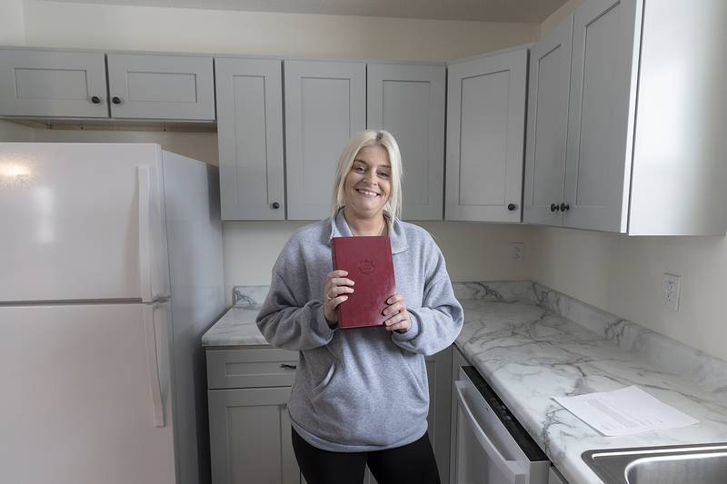 Megin Steeb shows off her new Bible that comes with every new Dixon Habitat for Humanity dedication. Steeb took ownership of the home on Sunday, Dec. 22, 2024.