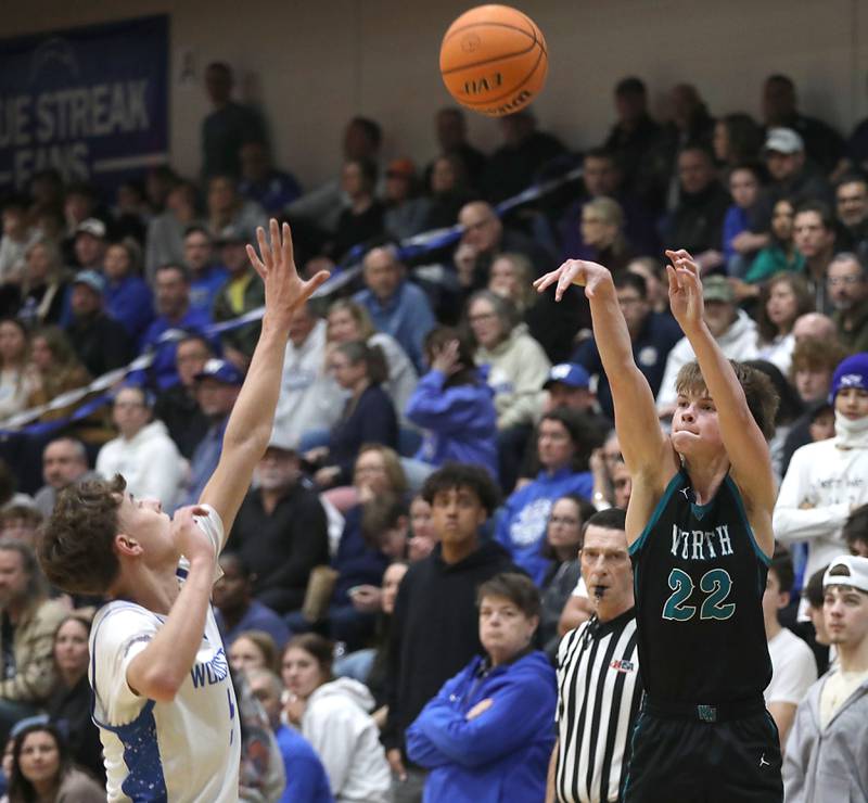 Woodstock North's Curtis Czeslawski shoots the ball over Woodstock's Max Beard during a Kishwaukee River Conference boys basketball game on Wednesday, February. 18, 2026, at Woodstock High School.