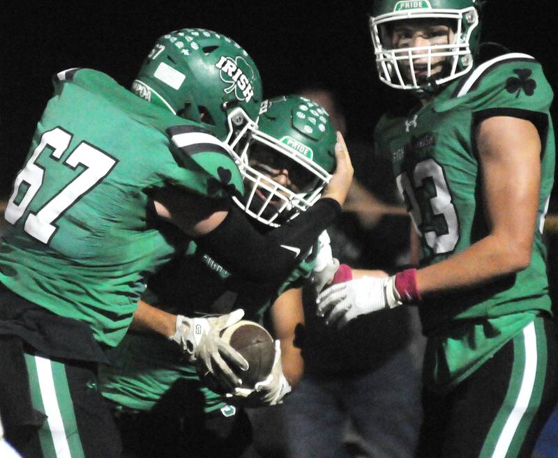 Seneca seniors Jace Mitchell (67), Ethan Othon and Brady Sheedy (23) celebrate Othon's touchdown Friday, Oct. 17, 2025 at Seneca High School.