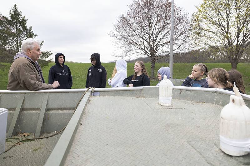 Bill Klostermann talks to West Carroll Middle School students about the boat used to deliver the walleye to different parts of the lake during the open house on Wednesday, April 20, 2023. Many fish thrive in Lake Carroll, except walleye that needs help due to the lake’s nature.