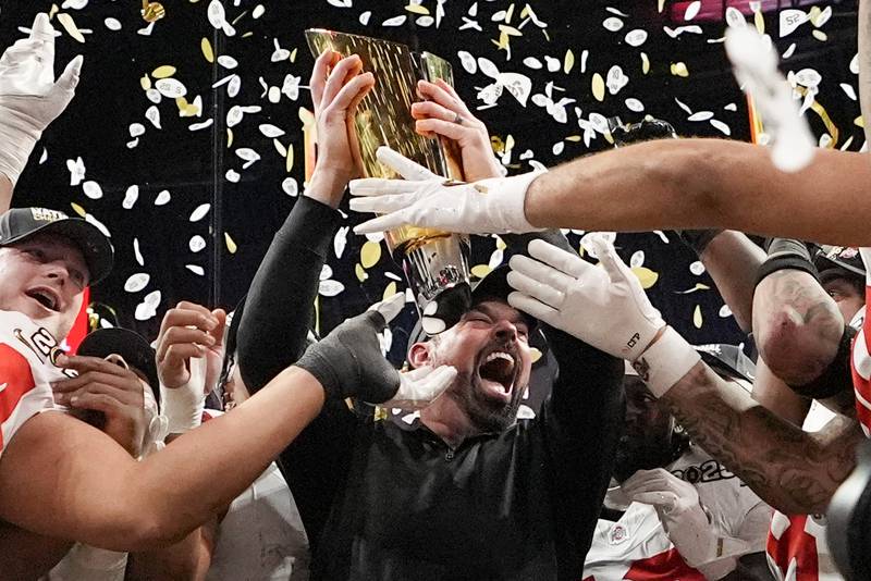 Ohio State head coach Ryan Day celebrates with the trophy after their win against Notre Dame in the College Football Playoff national championship game Monday, Jan. 20, 2025, in Atlanta. (AP Photo/Brynn Anderson)