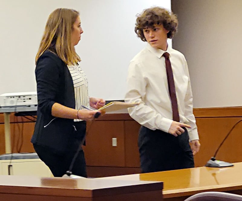 Clayton Davis, 18, of Polo, leaves an Ogle County courtroom with his private attorney, Cristina Buskohl of Mertes & Mertes in Sterling, after being sentenced to four years' probation for possession of child pornography.