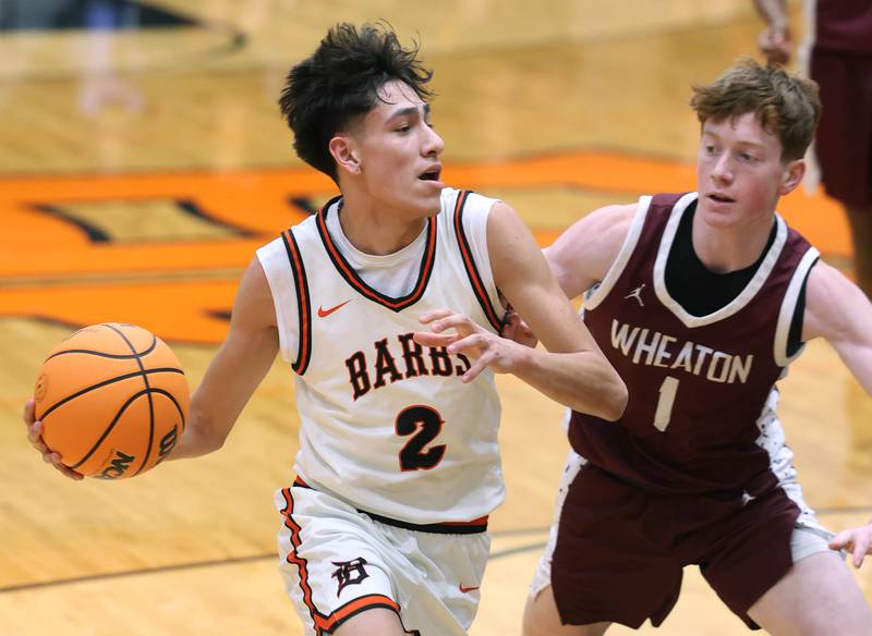 DeKalb's Aaron Ziga goes to the basket against Wheaton Academy's Josiah Nichols during their game Wednesday, Jan. 14, 2026, at DeKalb High School.
