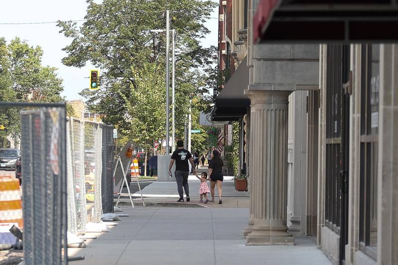 A family walks along North Chicago Street on Thursday, Sept. 12, 2024 in downtown Joliet.